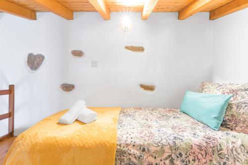 a bedroom with a bed with two towels on it at Herdade Vale de Gaios in Odemira