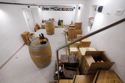 a room filled with boxes and wine barrels at Pri Žabarju Bed & Breakfast Ljubljana in Ljubljana