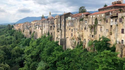 a large building on the side of a mountain at Filocase Comfortable Hideout in SantʼAgata deʼ Goti