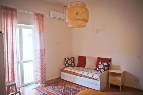 a living room with a couch and a window at Filocase Comfortable Hideout in SantʼAgata deʼ Goti
