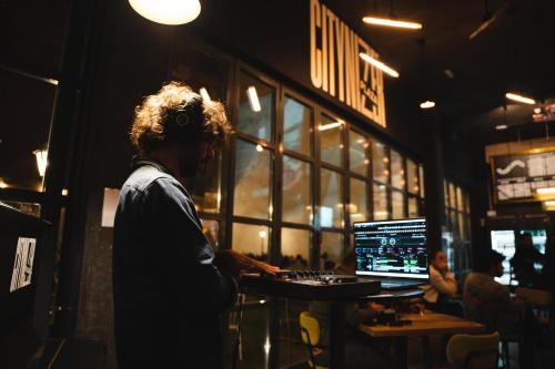 a man sitting at a table with a laptop computer at The Central House Madrid Lavapiés in Madrid