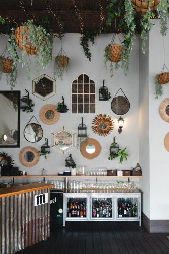 a room with a wall filled with lots of hanging plants at The Central House Madrid Lavapiés in Madrid