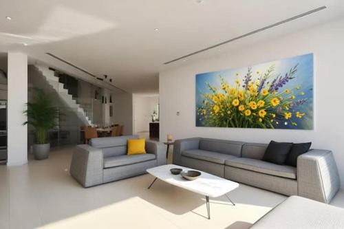 a living room with two couches and a painting of flowers at Beachfront Luxury Villa Glory in Ayia Napa