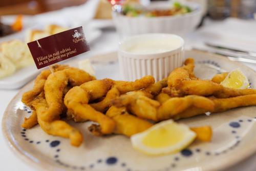 a plate of food with fried calamari on a table at Pri Žabarju Bed & Breakfast Ljubljana in Ljubljana