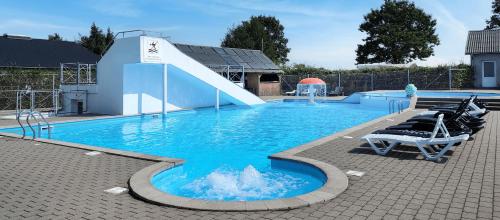 a swimming pool with a slide in the middle at Cabin - Hütte - Hytte, Svendborg in Svendborg