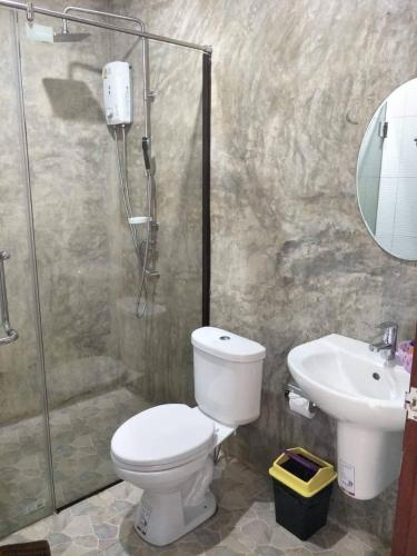 a bathroom with a shower and a toilet and a sink at The Aireen Hotel in Ao Nang Beach