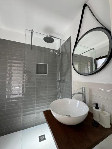 a bathroom with a white sink and a mirror at La Concha del Mar in Corralejo