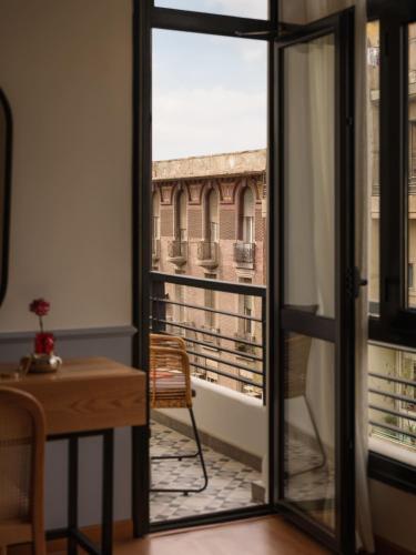 a view of a balcony from a room with a window at Brassbell l Downtown l Kasr Living l Tahrir sq in Cairo