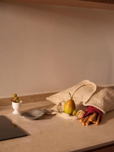 a table with a cloth and fruits and vegetables on it at Brassbell l Downtown l Kasr Living l Tahrir sq in Cairo