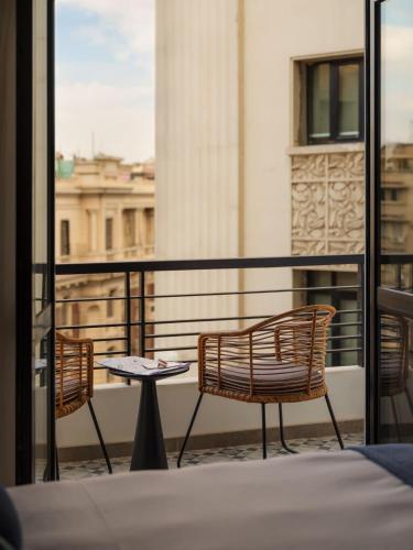 two chairs and a table on a balcony at Brassbell l Downtown l Kasr Living l Tahrir sq in Cairo