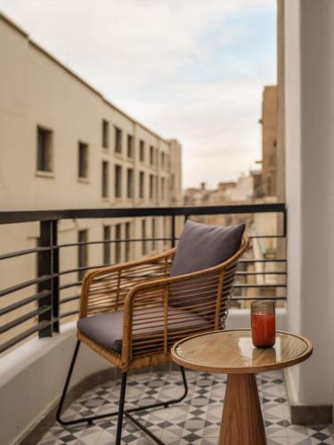 a chair and a table on a balcony at Brassbell l Downtown l Kasr Living l Tahrir sq in Cairo
