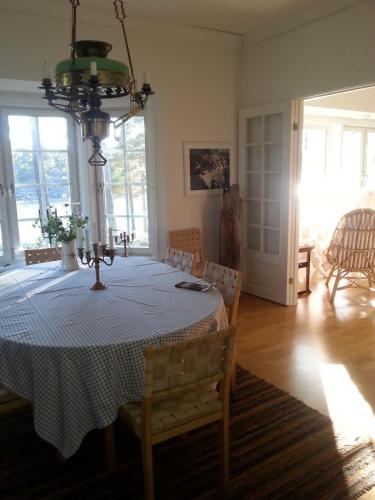 a dining room with a table and a chandelier at Villa Markomby in Markomby