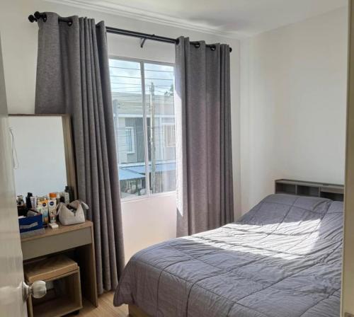 a bedroom with a bed and a window at Beautiful 2 Floor Home in Phuket Town in Phuket Town