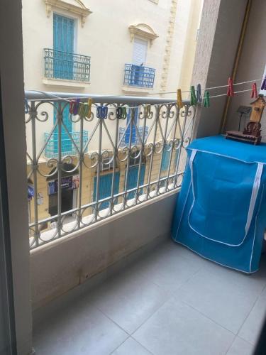 a balcony with a fence and a blue table at La perle de La Goulette in La Goulette