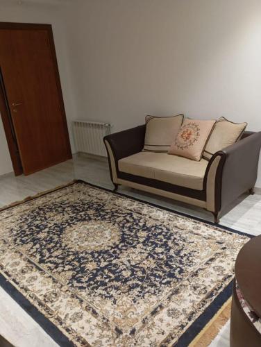 a living room with a couch and a rug at La perle de La Goulette in La Goulette