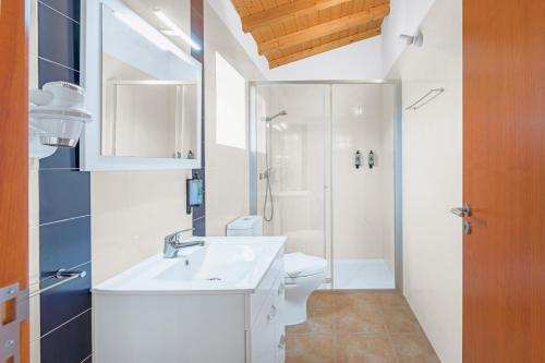a bathroom with a sink and a toilet and a shower at Herdade Vale de Gaios in Odemira