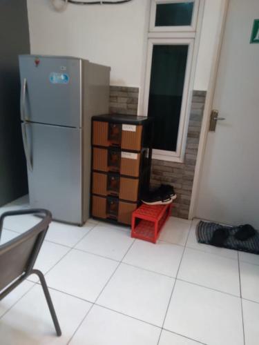a kitchen with a refrigerator and a window at Mgd kos syariah Sentul in Citaringgul 1