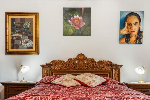 a bedroom with a bed with two pictures on the wall at Bruna's House in Domusnovas