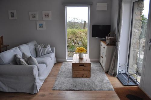 a living room with a couch and a tv at Morley's in Stithians