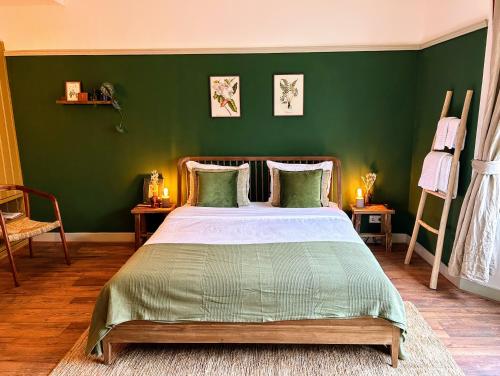 a bedroom with a bed with a green wall at Logement Petit Beijers in Utrecht