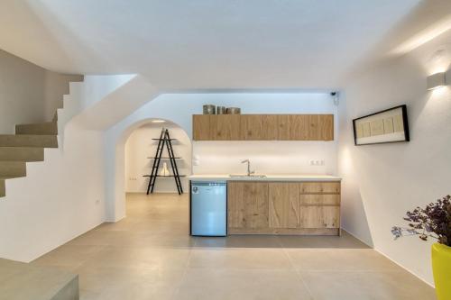 a kitchen with a blue refrigerator and a staircase at Villa Primrose in Kampos Paros