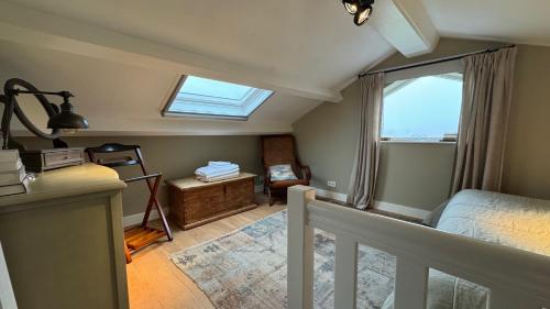 a attic room with a bed and a window at De Lindenhof in Tienhoven