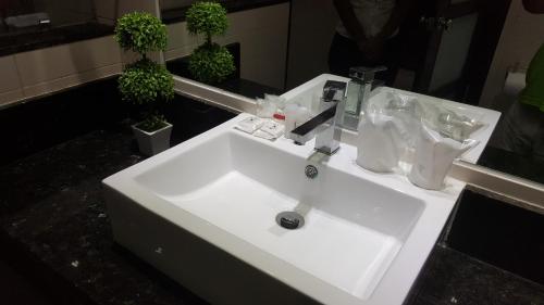 a white sink in a bathroom with a mirror at Savoy Hotel Boutique in Las Terrenas
