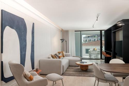a living room with a couch and a table at Savoy Insular V by An Island Apart in Funchal