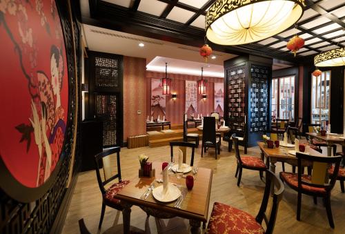 a dining room with tables and chairs in a restaurant at Adalya Elite Lara Hotel - Ultra All Inclusive in Lara
