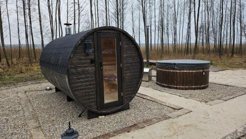 a small dome house sitting next to a trash can at Jak Tu Sielsko in Osiek