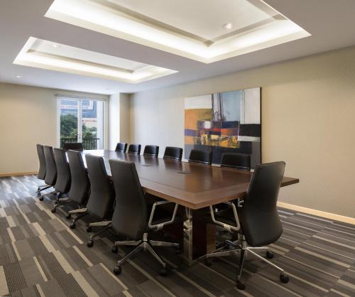 a conference room with a long table and chairs at Ayaka Suites in Jakarta