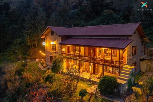 a large house with lights on in the yard at Zostel Homes Laida (Jibhi) in Sainj