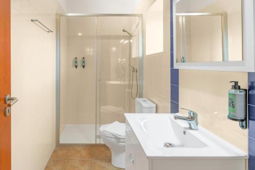 a bathroom with a shower and a sink and a toilet at Herdade Vale de Gaios in Odemira