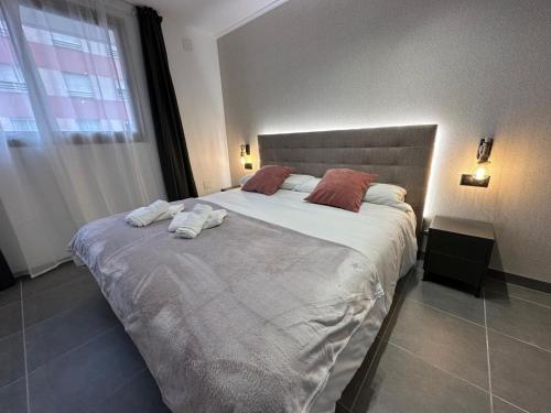 a bedroom with a large bed with towels on it at AH Rentals Suites in Vinarós