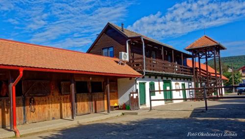a group of buildings on a street at Lovas Udvarház Ezüst Zabla Apartman Piliscsaba in Piliscsaba