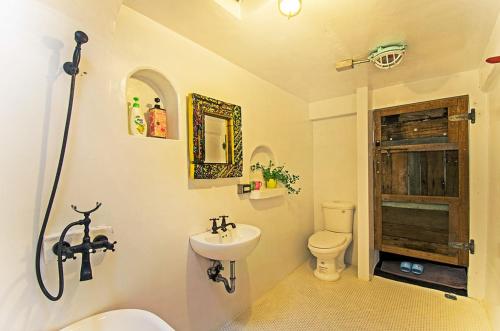 a bathroom with a sink and a toilet at Flower House B&B in Jiufen