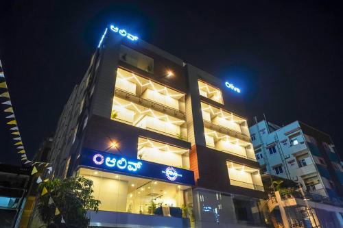 a building with a sign on it at night at Olive Hotel Kundalahalli by Embassy Group in Bengaluru