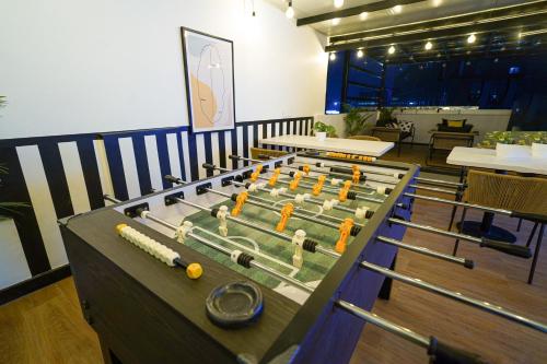 a table with a bunch of baseball bats on it at Olive Hotel Kundalahalli by Embassy Group in Bengaluru