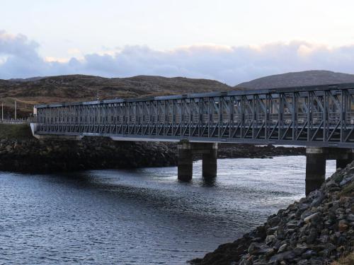 a train crossing a bridge over a river at Loch View in Breaclete
