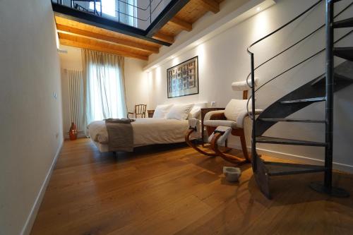 a bedroom with a bed and a chair in a room at Villa Podere Gaia 16 Pax by VILLASRETREATS in Sasseta