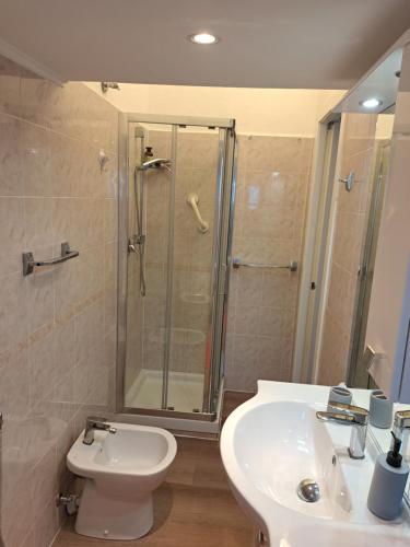 a bathroom with a shower and a toilet and a sink at Sirena in Genova