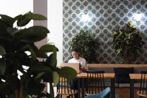 a man sitting at a table with a laptop at The Central House Lisbon Baixa in Lisbon