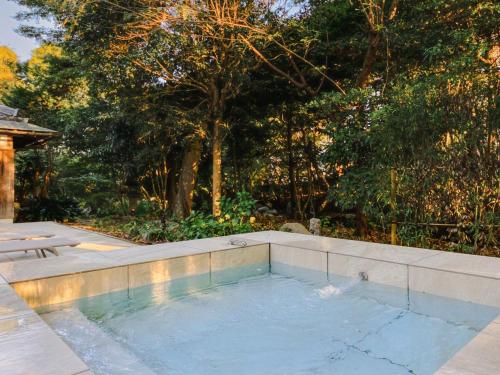 a swimming pool in a yard with trees at NIPPONIA HOTEL 伊賀上野 城下町 in Iga