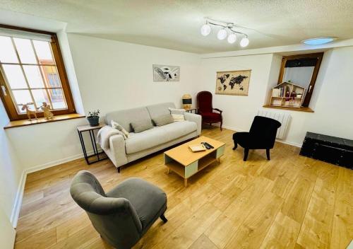 a living room with a couch and a table at LA RUELLE ALSACIENNE, Charme Alsacien et Confort Moderne in Riquewihr