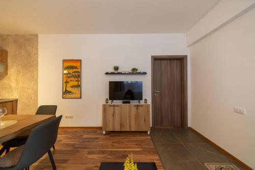 a living room with a table and a television at Castelomi in Podgorica