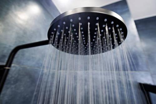 a shower head with water coming out of it at Your Luxury Home away from Home in Gwarinpa