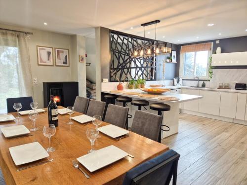 a dining room with a table and chairs and a kitchen at Villa Élégante à Berre-les-Alpes - Terrasse, Piscine & Vue Panoramique in Berre-les Alpes