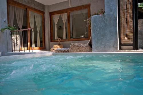 a large pool of water in front of a house at Proud Phu Fah Maerim Resort in Mae Rim