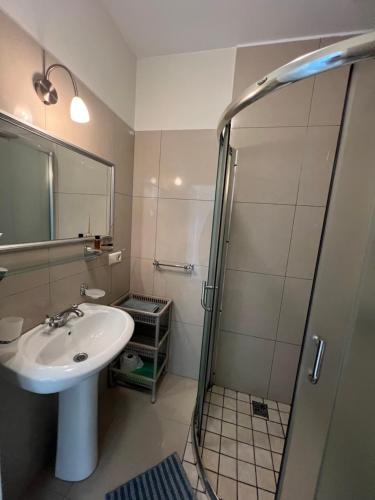 a bathroom with a sink and a shower at Pilaites svetingi namai in Vilnius