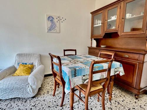 a dining room with a table and a chair at Casa Margherita in Ospedaletti